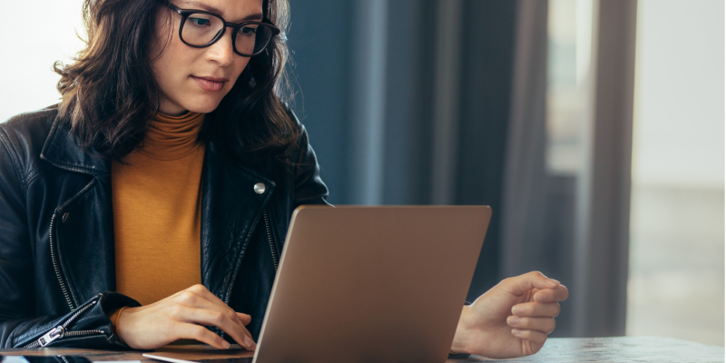 Woman researching how to become a life coach in the UK on her laptop