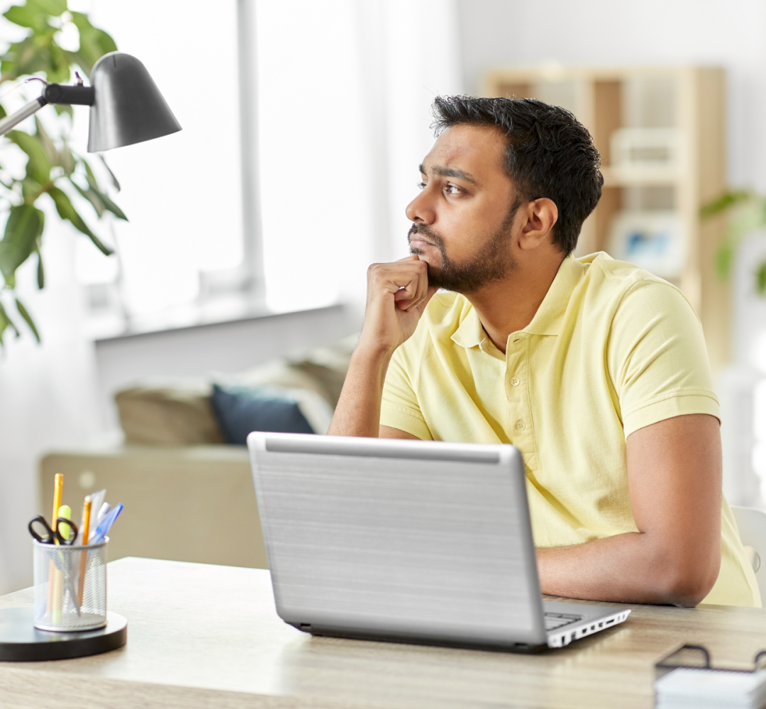 Man at laptop thinking about how long it takes to become a life coach