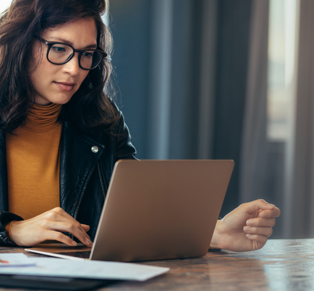 Woman researching how to become a life coach in the UK on her laptop