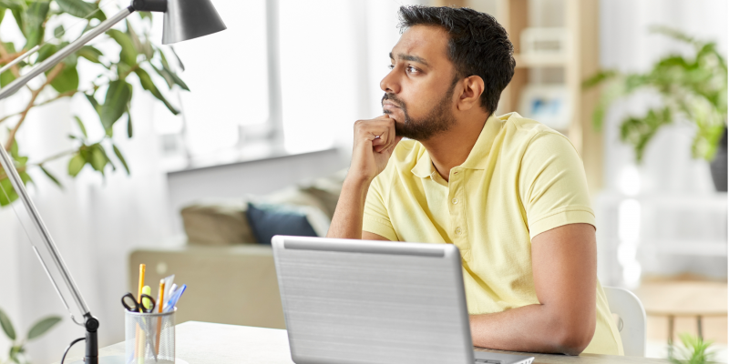 Man at laptop thinking about how long it takes to become a life coach