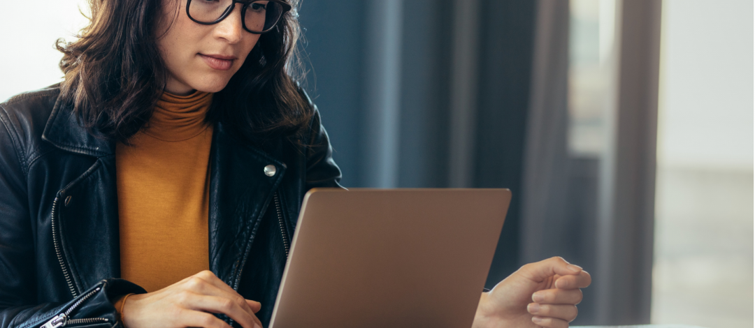 Woman researching how to become a life coach in the UK on her laptop