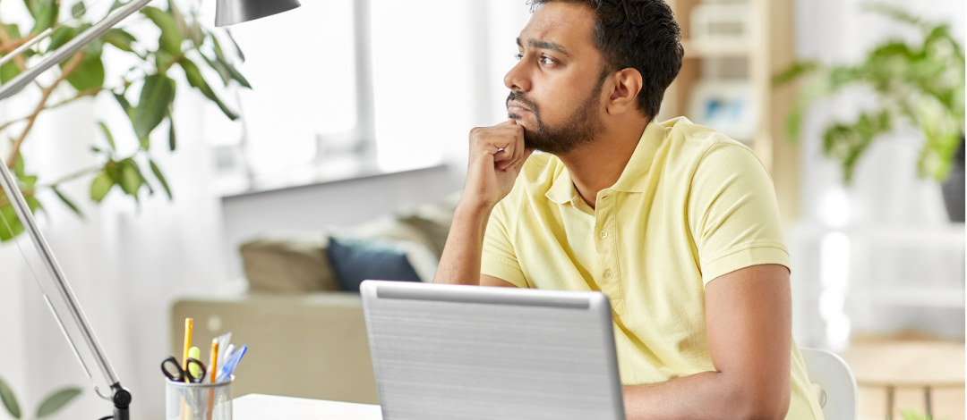Man at laptop thinking about how long it takes to become a life coach