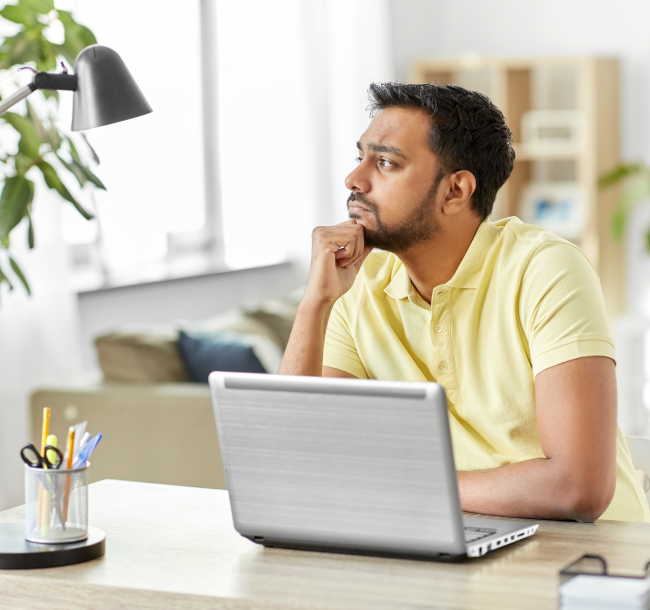 Man at laptop thinking about how long it takes to become a life coach
